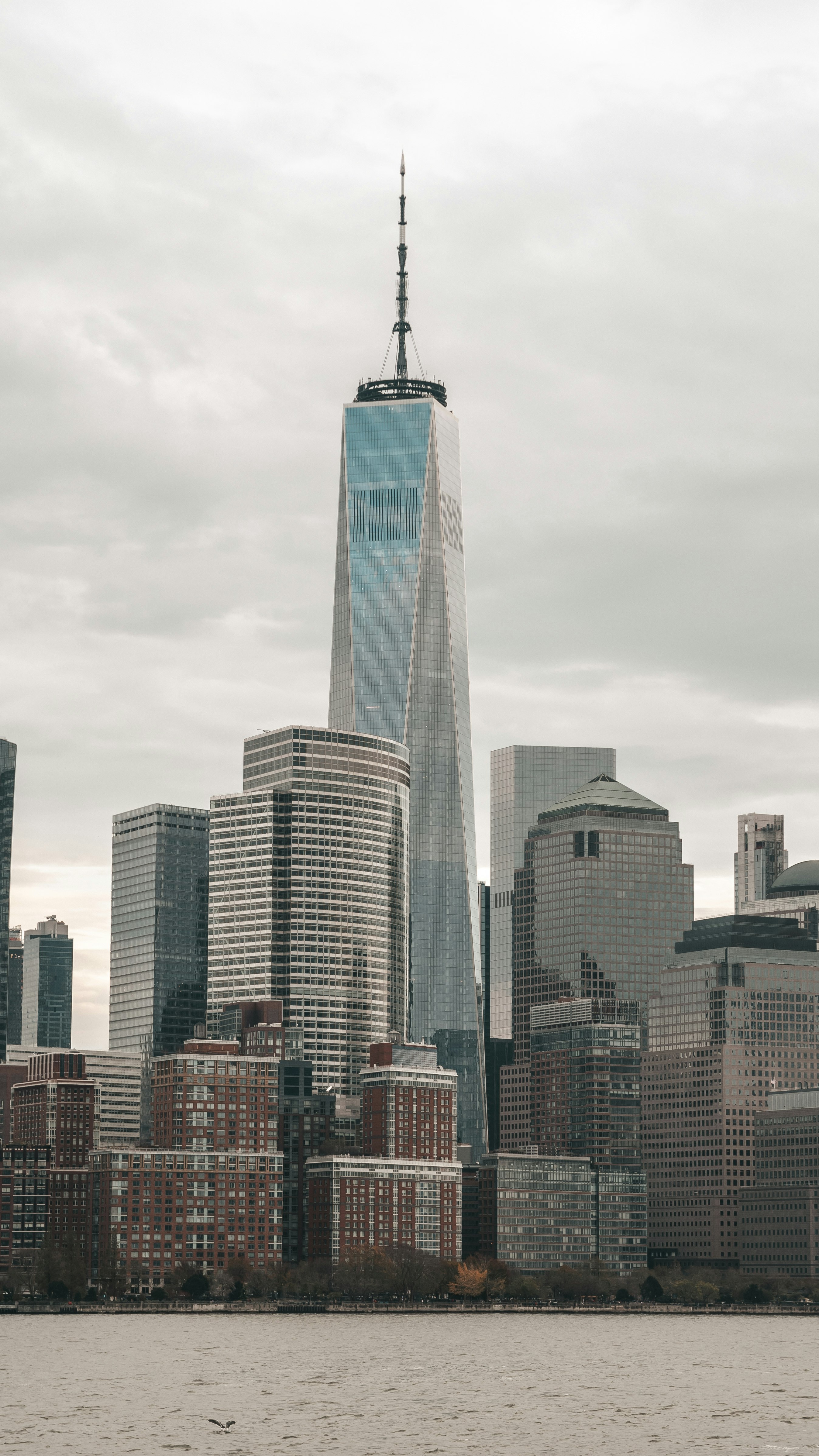 high rise buildings under white clouds during daytime